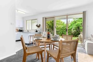 a kitchen and dining room with a table and chairs at The Little Husky by Experience Jervis Bay in Huskisson