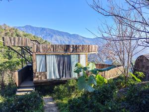 a tiny house with a window in the mountains at Cloud Garden in Bắc Yên