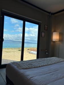 a bedroom with a bed and a view of the beach at Grand Ocean View Suite with Private Pool in La Paz +84 photos