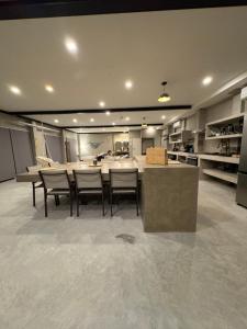 a kitchen with a table and chairs in a room at Grand Ocean View Suite with Private Pool in La Paz