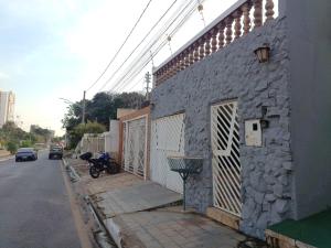 a motorcycle parked on the side of a building at Hostel Goiabeiras in Cuiabá