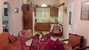 a living room with a couch and a kitchen at Elisabeth Villas in Kerveli