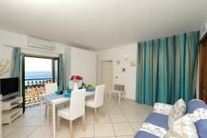 a living room with a dining table and a view of the ocean at Fruit Flats by AMALFIVACATION in Minori