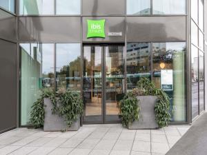 a store front with potted plants in front of it at ibis Styles Bezons Paris La Défense in Bezons