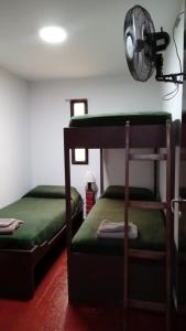 a bedroom with two bunk beds and a fan at Dúplex complejo - Centro Villa Gesell - 5 huéspedes in Villa Gesell
