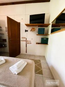 a bedroom with a bed and a tv on the wall at Gîtes Kaz Tchò in Sainte-Anne