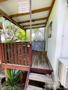 a wooden deck with awning on a house at Gîtes Kaz Tchò in Sainte-Anne