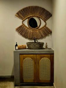 a bathroom with a mirror and a counter with a sink at Casa Carmen Hostel in Weligama