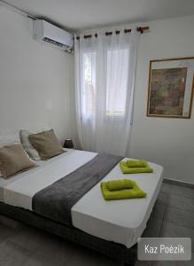 a bedroom with a large bed with green towels on it at Gîtes Kaz Tchò in Sainte-Anne +23 photos