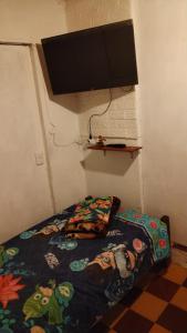 a bedroom with a bed and a flat screen tv at Casa cerca de la playa in La Paloma