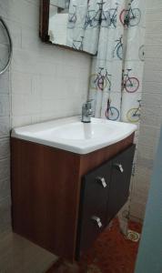 a bathroom with a white sink and a mirror at Casa cerca de la playa in La Paloma