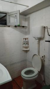 a small bathroom with a toilet and a sink at Casa cerca de la playa in La Paloma +6 photos