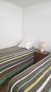 Ένα ή περισσότερα κρεβάτια σε δωμάτιο στο CostaQuilen Departamento