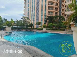 a large blue swimming pool in front of a tall building at Modern 1 bedroom spacious apartment with Venice Grand Canal View in Manila