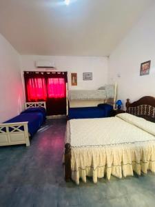 En eller flere senge i et værelse på Hospedaje Loli