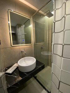 un baño con lavabo y espejo en MBS HOTEL Medan, en Medan