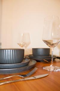 a table with plates and glasses of wine on it at Studio - Cozy Downtown Hideaway in Sudbury