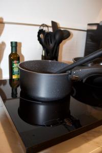 a black pot sitting on top of a stove at Studio - Cozy Downtown Hideaway in Sudbury +9 photos