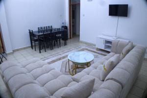 a living room with a couch and a table at Alpha Homes in Mombasa
