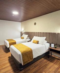 En eller flere senge i et værelse på Casa Tiyay