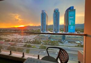 a balcony with a view of a city with buildings at Elysium Tower Premium Serviced Apartments Facing Centaurus Mall Islamabad in Islamabad