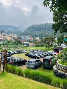 a bunch of cars parked in a parking lot at Ndalem Prabu Sarangan in Sarangan +4 photos