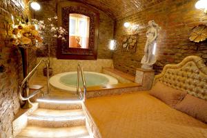 a bathroom with a tub with a statue in it at SPA Hotel Liliova Prague Old Town in Prague +75 photos