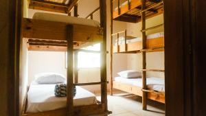two bunk beds in a room with a window at Drop House Hostel in Ubatuba +38 photos