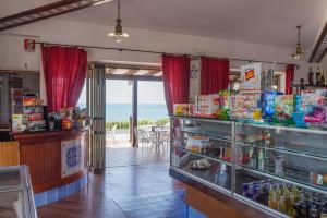 a restaurant with a bar with a view of the ocean at Holiday Village in Fondi