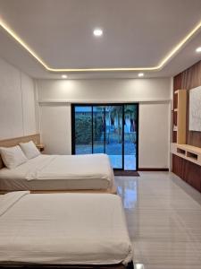 Postel nebo postele na pokoji v ubytování Lanta Mother House