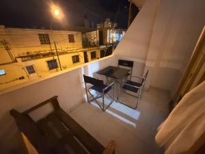 a view of a balcony with a table and chairs at Dulce Descanso in Salta