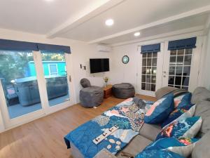 a living room with a couch and a tv at st pete pool house in St Petersburg