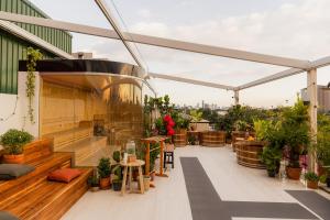 a balcony with a lot of plants and benches at The Fig Lobby Bangkok in Bangkok
