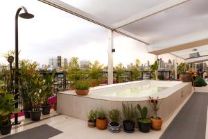 a hot tub on the roof of a building with plants at The Fig Lobby Bangkok in Bangkok +30 photos