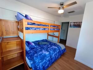 a bedroom with a bunk bed with blue sheets at st pete pool house in St Petersburg +45 photos