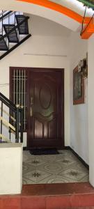 a large wooden door in a room with a tile floor at Shevaroyen villa yercaud in Yercaud