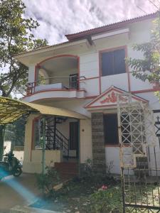 a house with a motorcycle parked in front of it at Shevaroyen villa yercaud in Yercaud