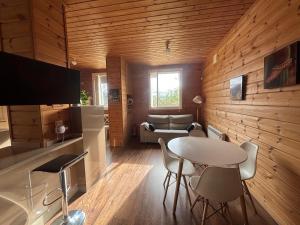 a living room with a table and chairs in a room at Arbegain Etxea in Aizarna