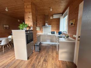 a kitchen with a refrigerator and a sink in a room at Arbegain Etxea in Aizarna +6 photos