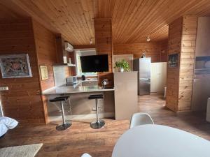 a kitchen with a counter and stools in a room at Arbegain Etxea in Aizarna