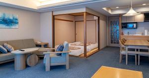 a living room with a couch and a bed at Seagaia Forest Condominiums in Miyazaki
