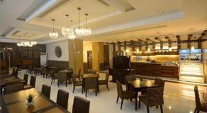 a dining room with tables and chairs in a restaurant at DIVERSION 21 HOTEL in Molo +39 photos