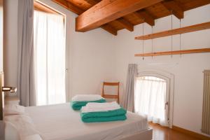 a bedroom with a bed with two towels on it at Stella Sport Apartments in Nago-Torbole