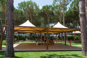 a group of tents in a park with trees at Holiday Village in Fondi