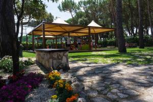 a pavilion in a park with a bunch of flowers at Holiday Village in Fondi