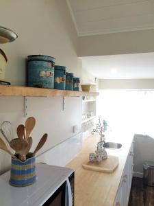 a kitchen with a counter with wooden utensils at Robin Hoods Well Farm Stay in Sassafras