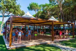 a group of children standing under a pavilion at a park at Holiday Village in Fondi