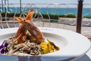 a plate of food with a seafood dish on a table at Holiday Village in Fondi