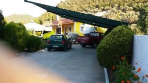 a car parked in a parking lot in front of a house at Elisabeth Villas in Kerveli