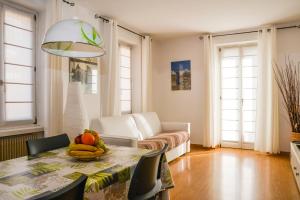 a living room with a table with fruit on it at Stella Sport Apartments in Nago-Torbole